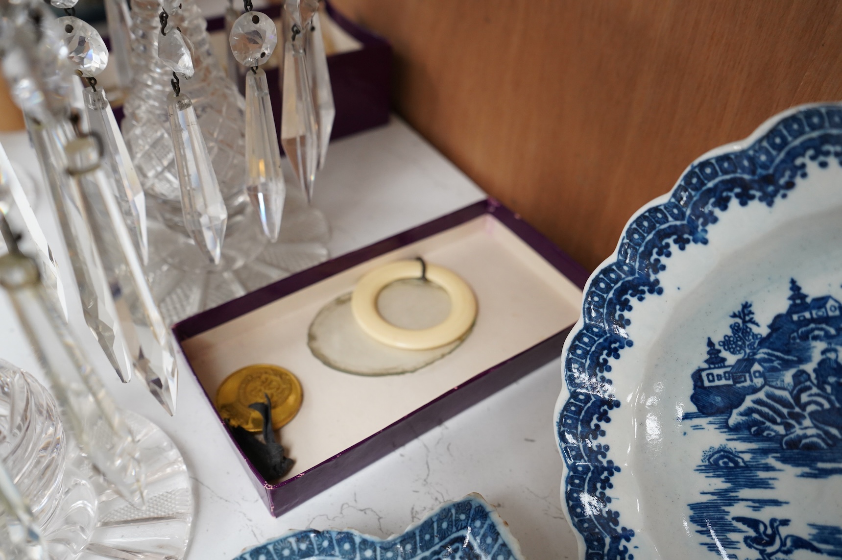 A pair of Victorian cut glass lustre candlesticks and one larger candlestick, 24cm high